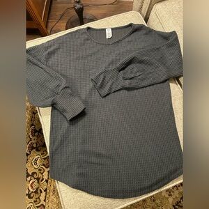 Charcoal gray waffle knit rounded hem top.
